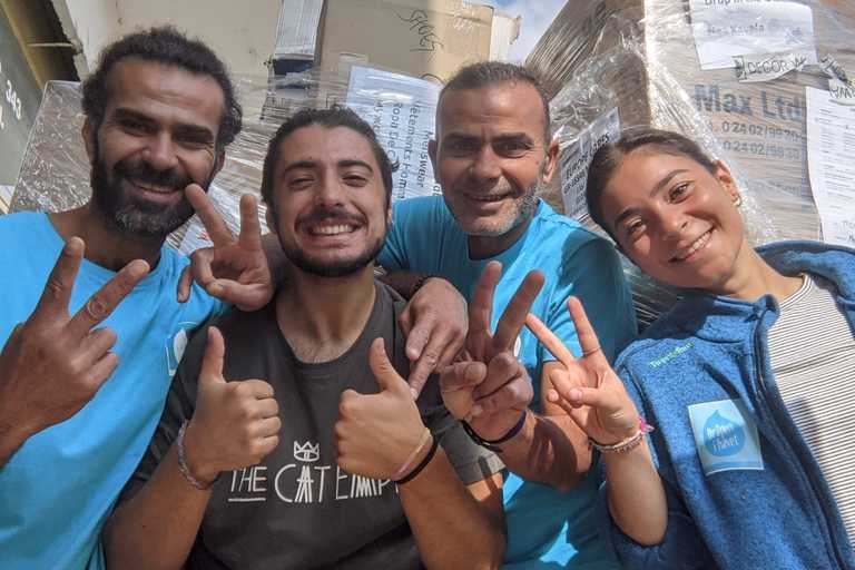 Volunteers huddled together, posing for a photo